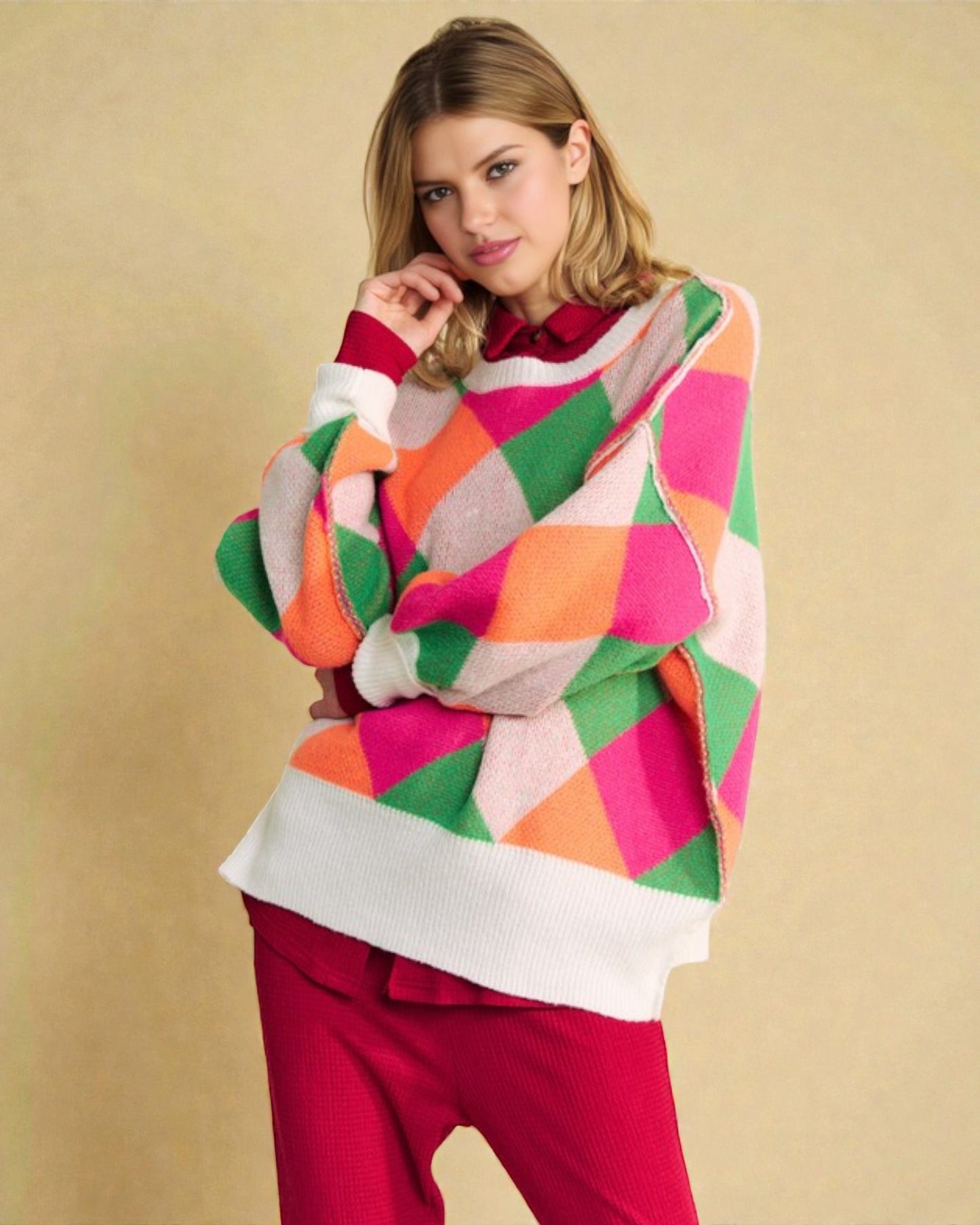 Woman wearing a colorful geometric-patterned sweater against a beige background