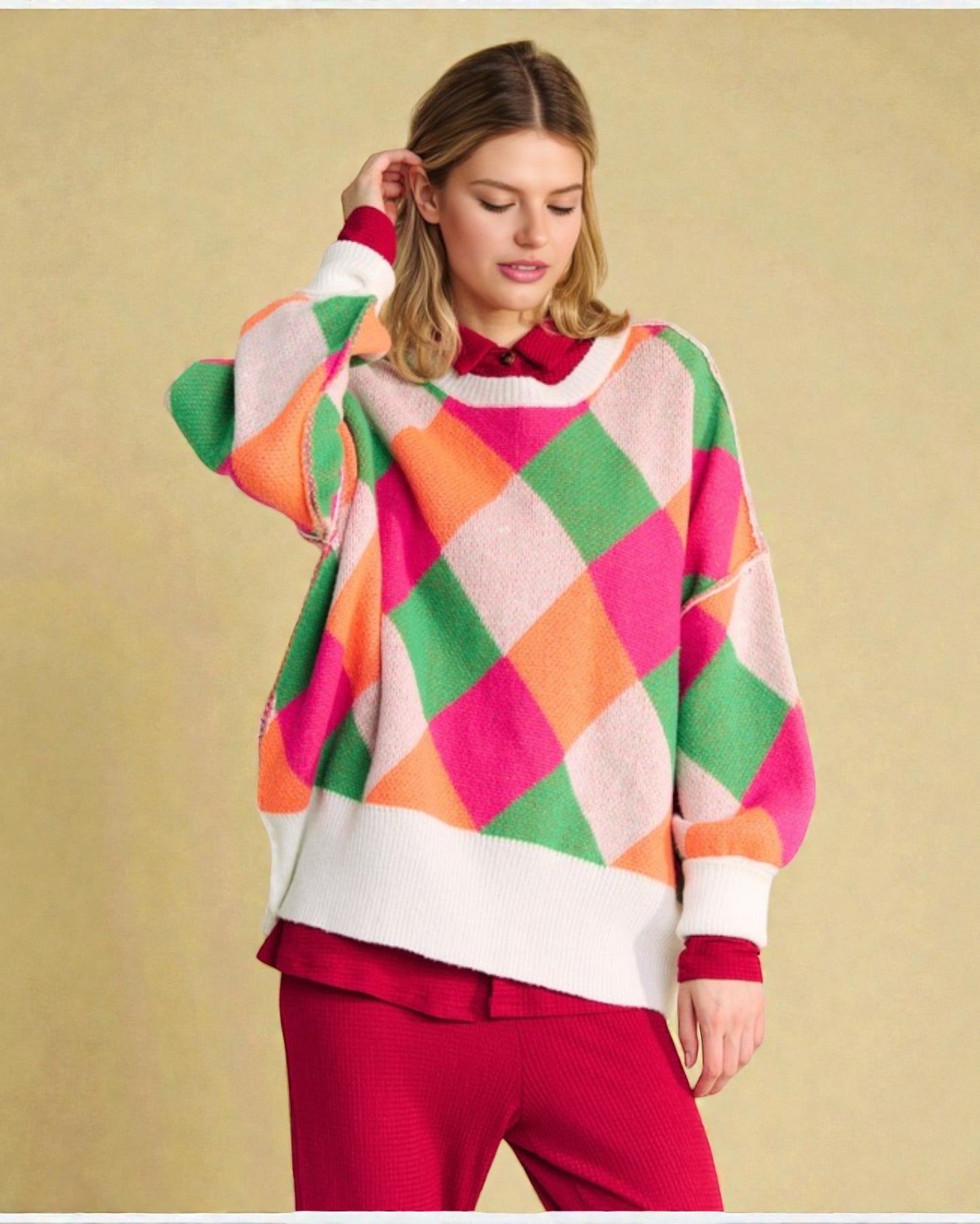 Woman wearing a colorful argyle sweater against a beige background