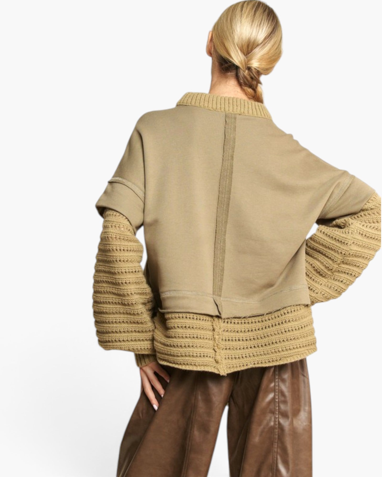 A woman shown from the back wearing a cropped knit cardigan with ribbed trim and brown wide-leg pants, photographed against a clean white studio background.