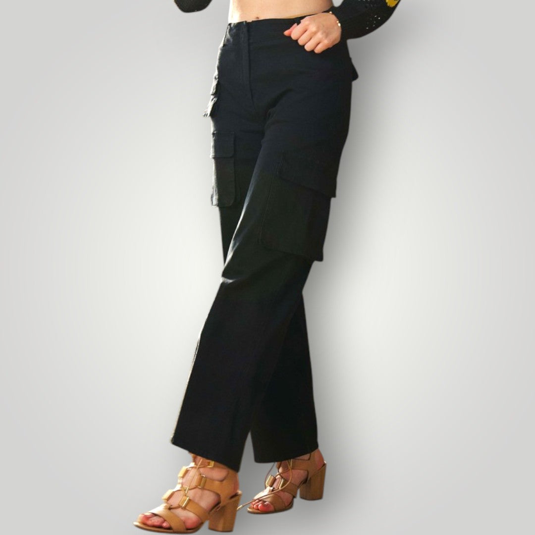 Person wearing black wide-leg pants on a white background