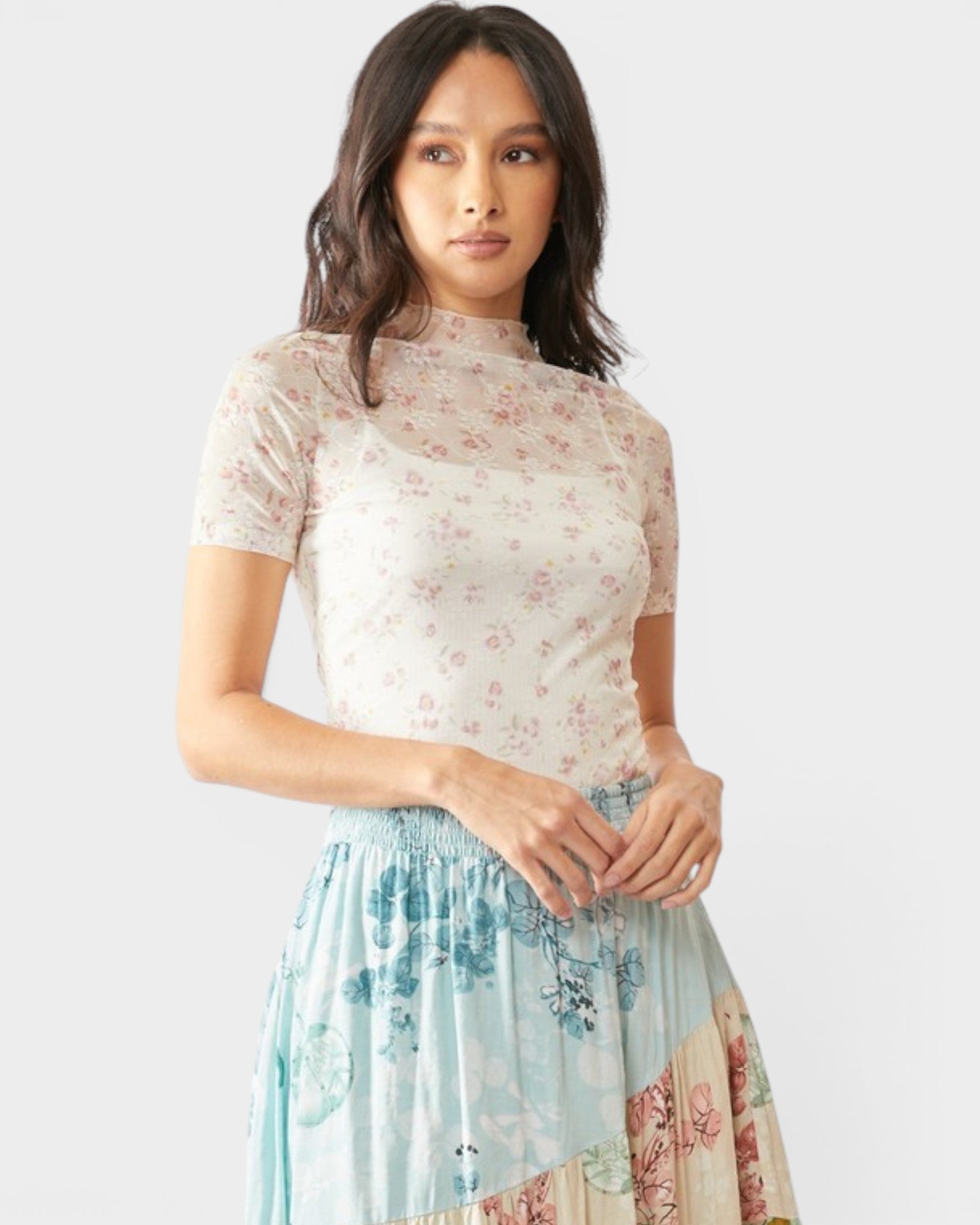 Woman wearing a floral dress with a plain background