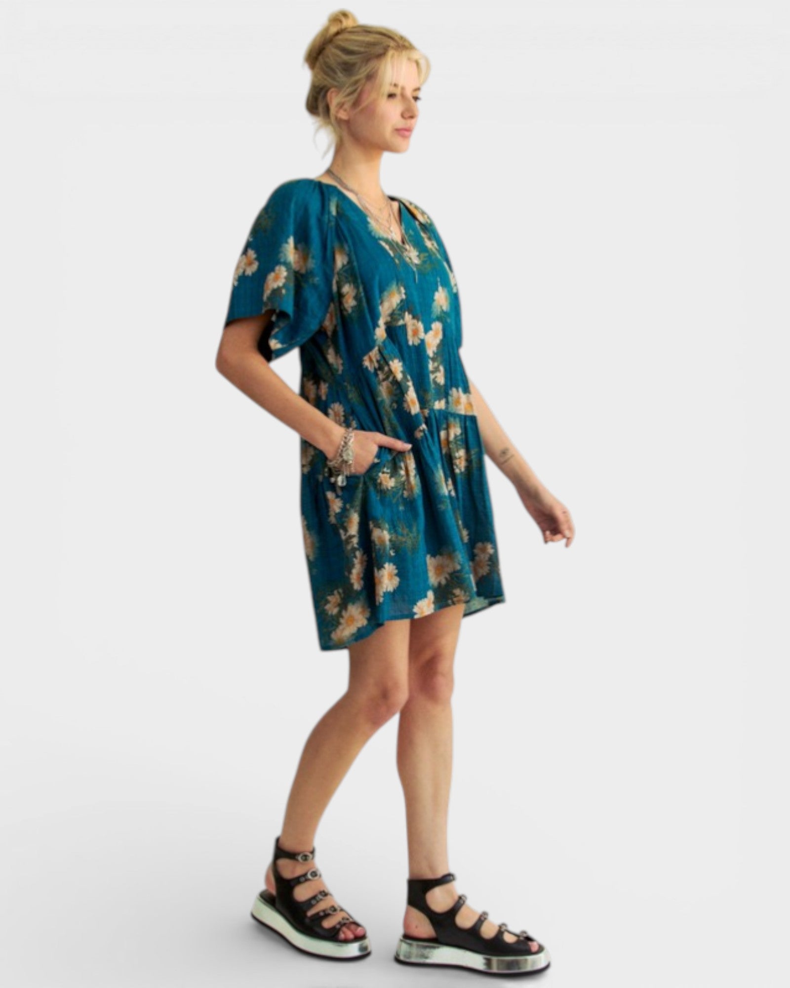 Woman wearing a blue floral dress on a white background