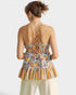 Woman wearing a colorful patterned dress with a white background