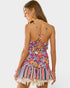 Woman wearing a colorful floral dress with a white background