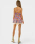 Woman wearing a colorful floral dress on a white background