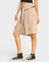 Beige skirt with a belt and black high-top sneakers on a white background