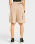 Beige shorts worn by a person on a white background