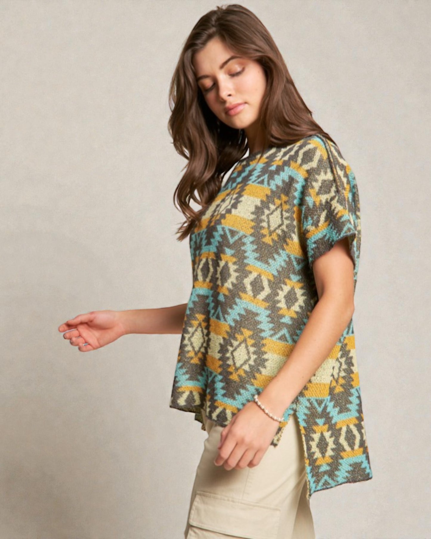 Woman wearing a patterned shirt with a neutral background