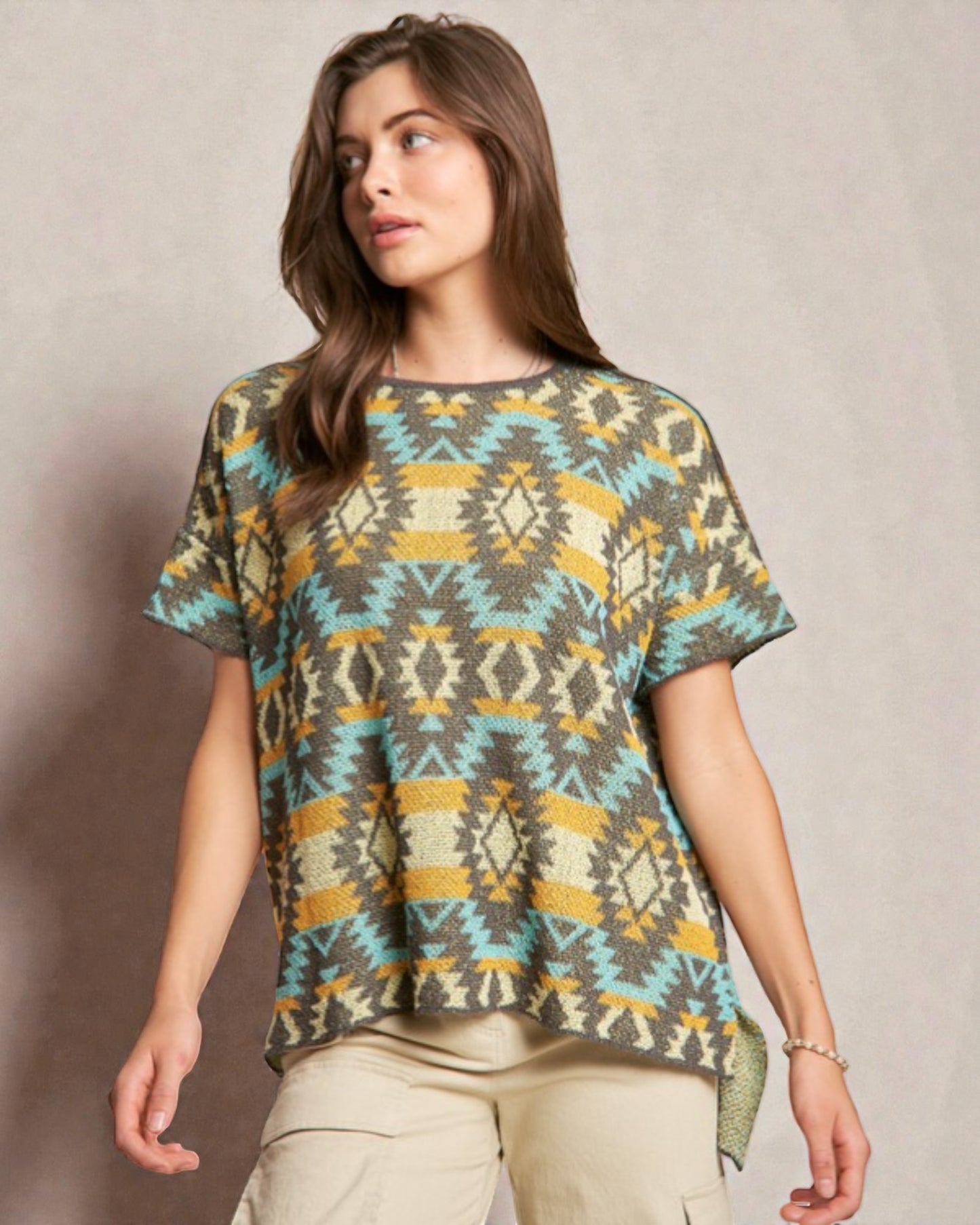 Woman wearing a patterned shirt against a plain background