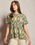 Woman wearing a patterned shirt against a plain background