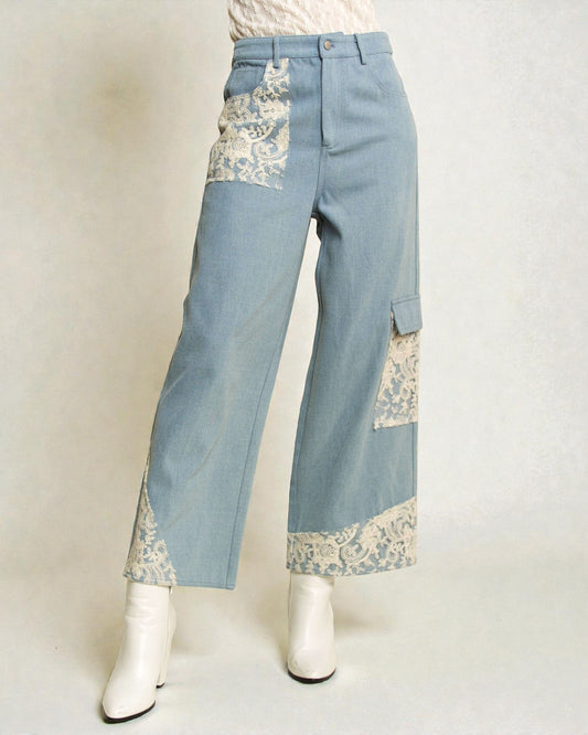 Light blue jeans with lace detailing on a white background