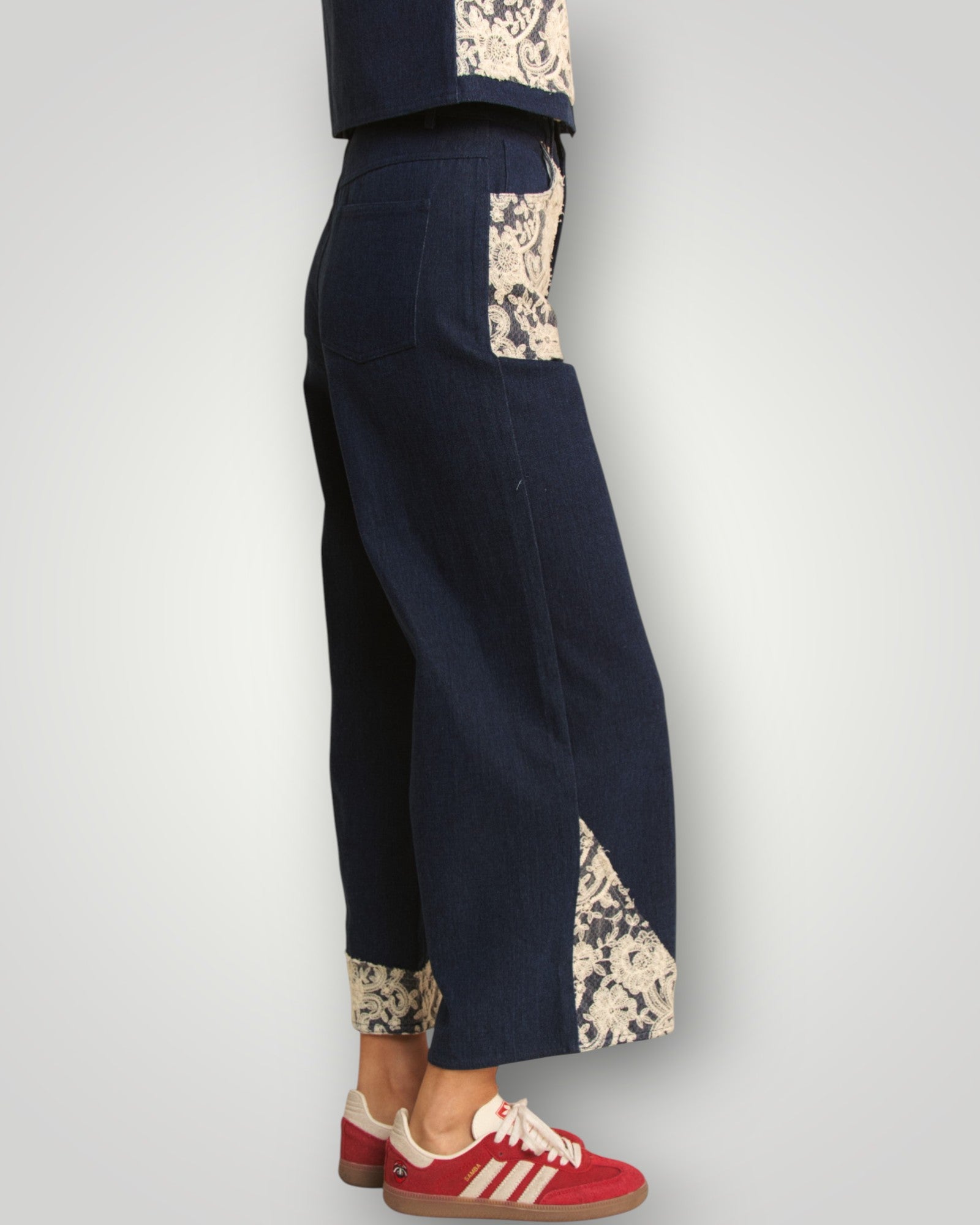 Navy pants with floral cuffs and hem on a white background
