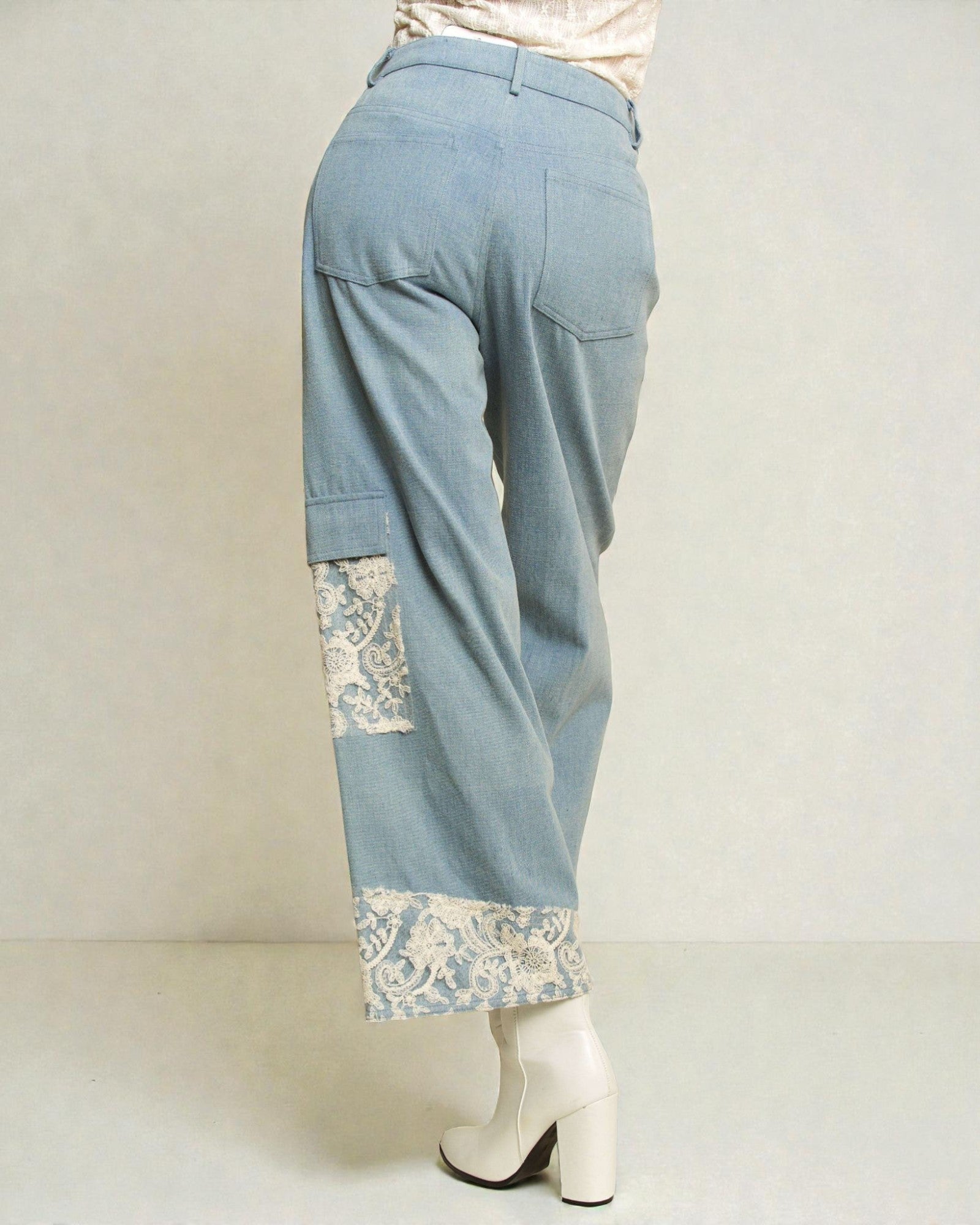 Light blue pants with lace trim on a white background