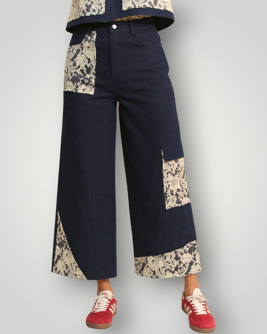 Navy pants with lace trim worn by a person on a plain background