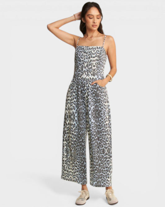 Woman wearing a leopard print jumpsuit on a white background