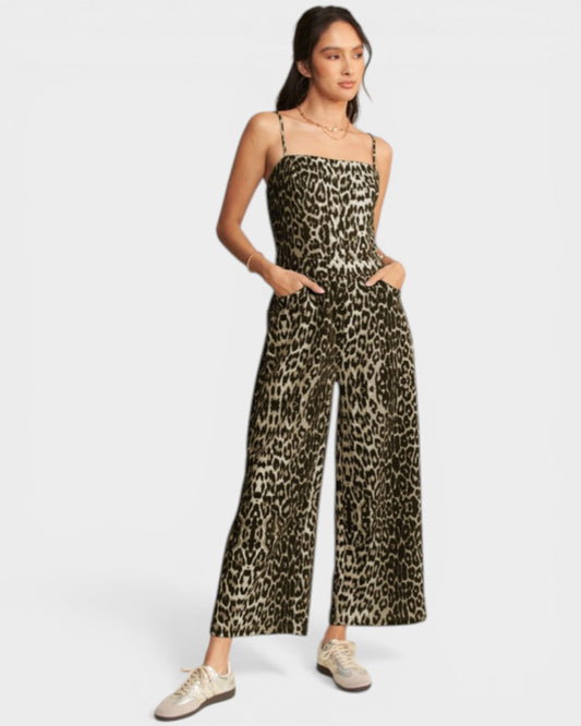 Woman wearing a leopard print jumpsuit on a white background