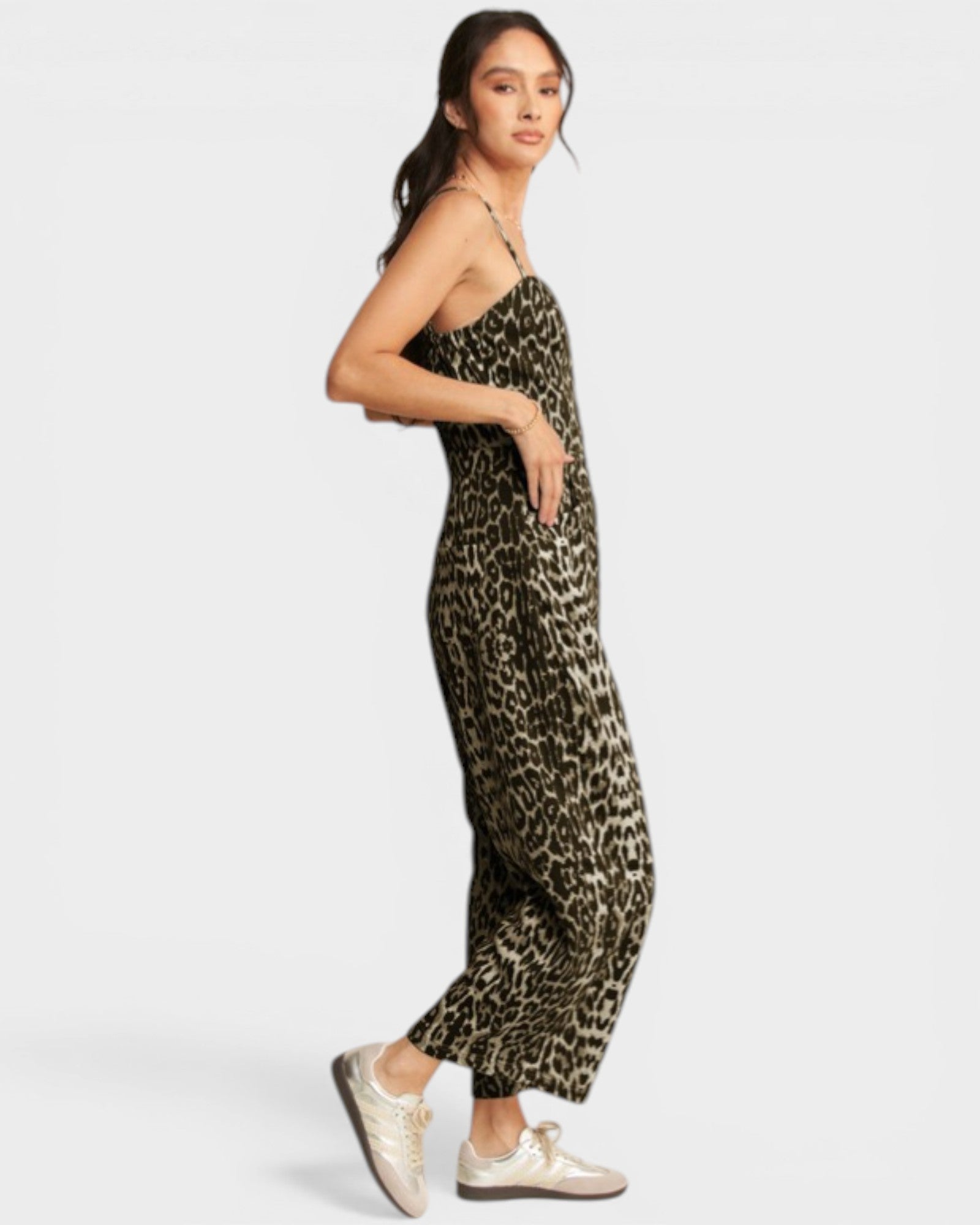Woman wearing a leopard print jumpsuit on a white background