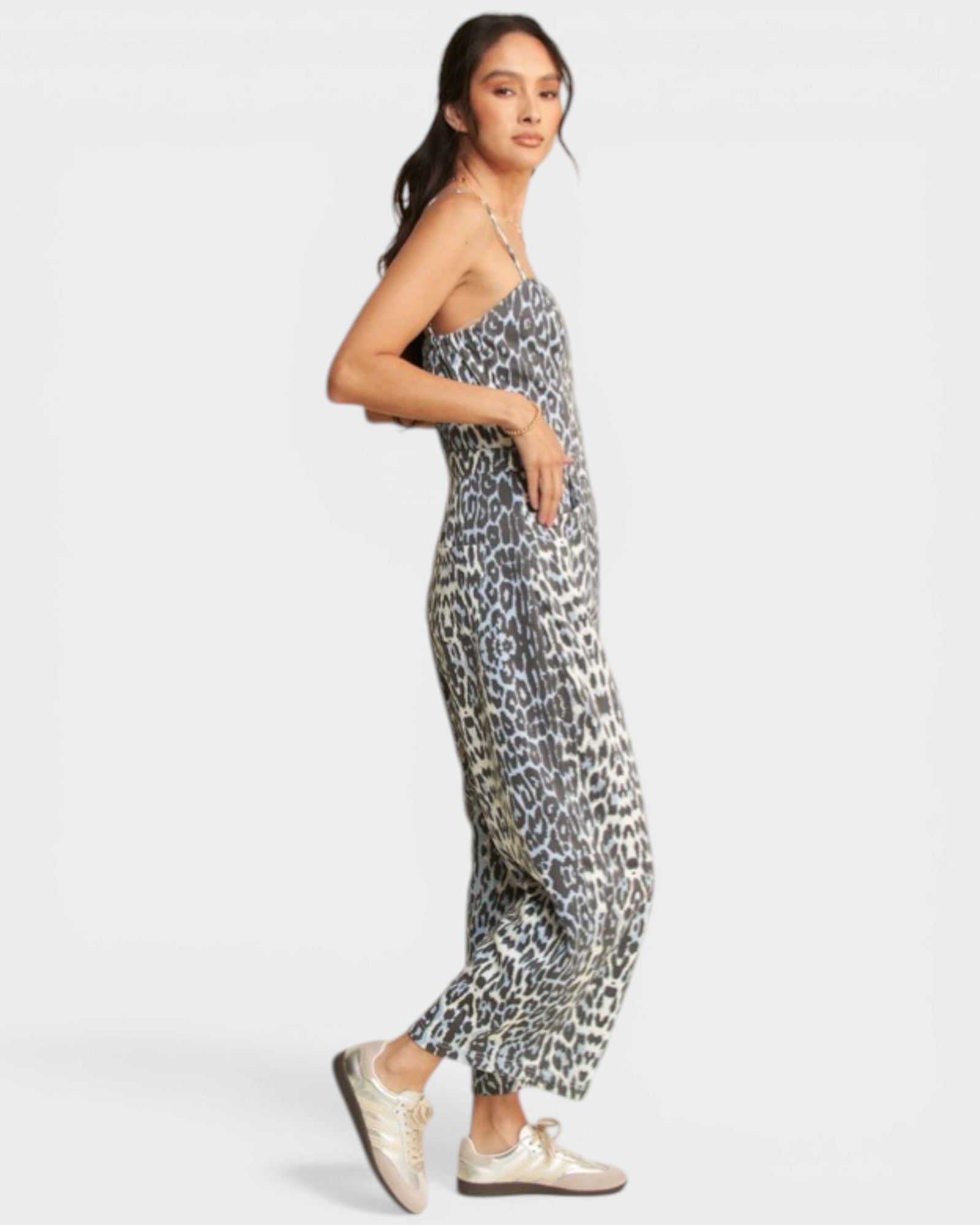 Woman wearing a leopard print jumpsuit on a white background