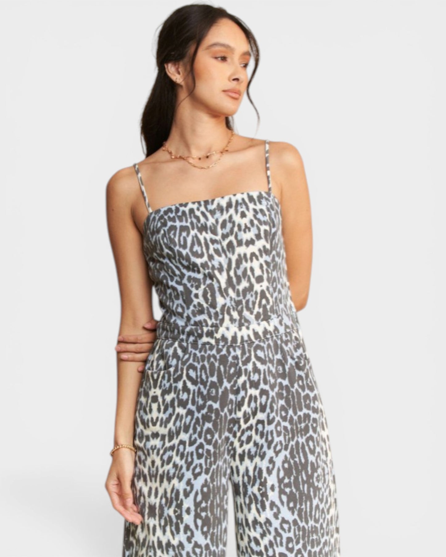 Woman wearing a leopard print dress on a white background