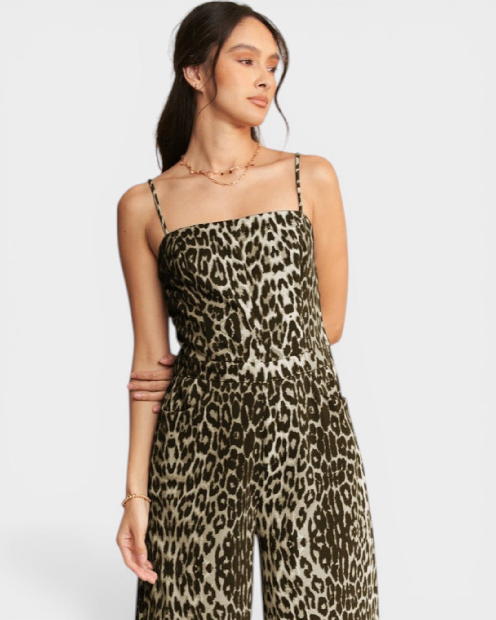 Woman wearing a leopard print dress on a white background