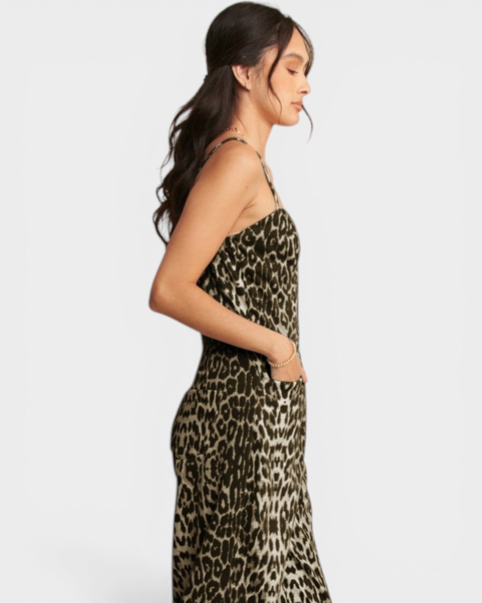 Woman wearing a leopard print strapless dress on a white background