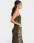 Woman wearing a leopard print strapless dress on a white background