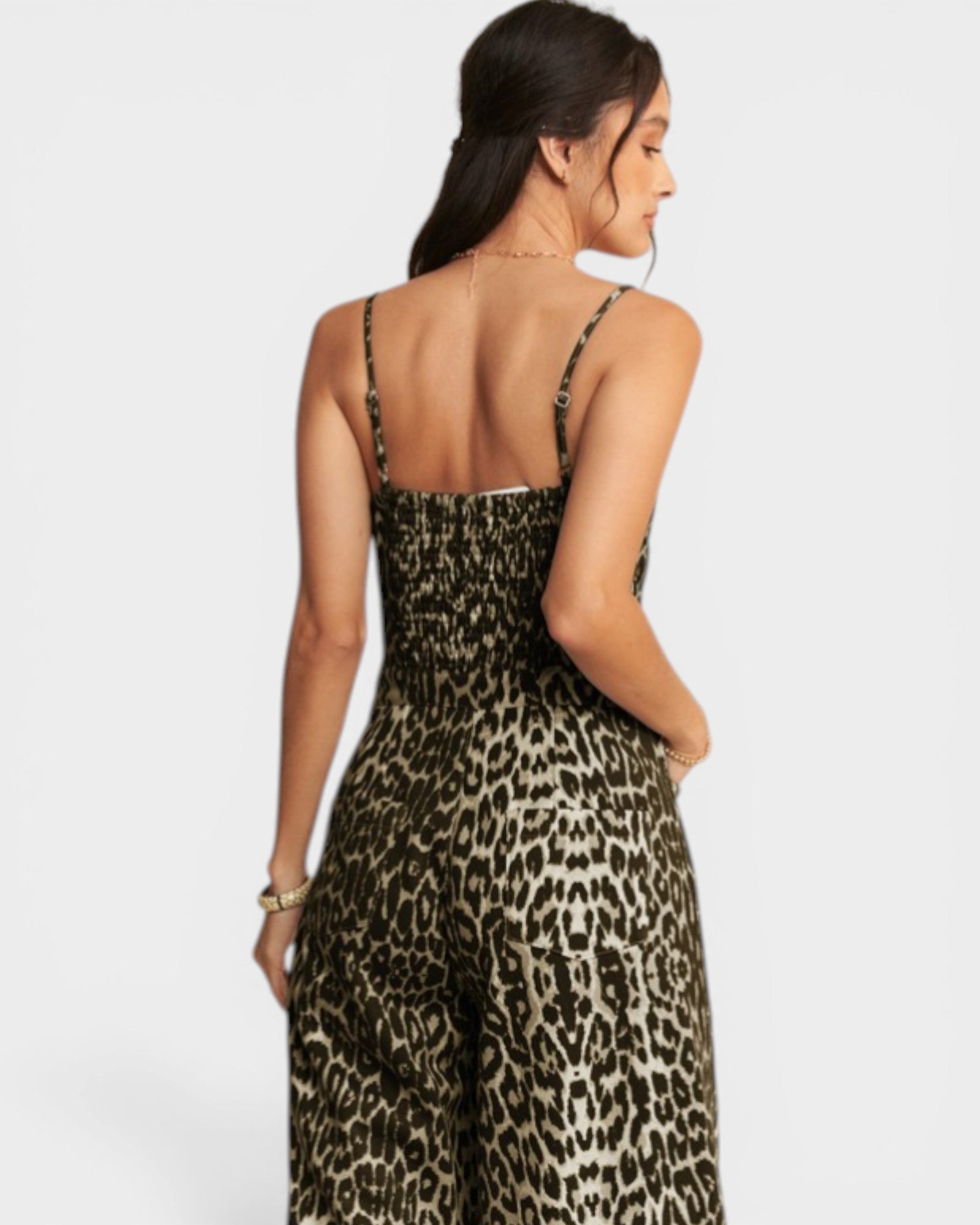 Woman wearing a leopard print dress on a white background