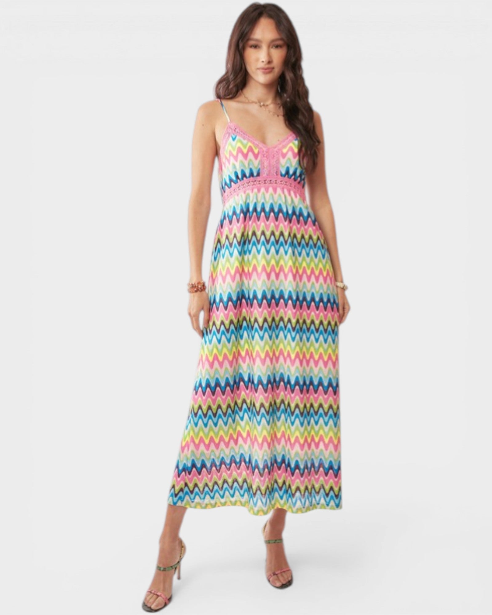 Woman wearing a colorful zigzag patterned dress on a white background