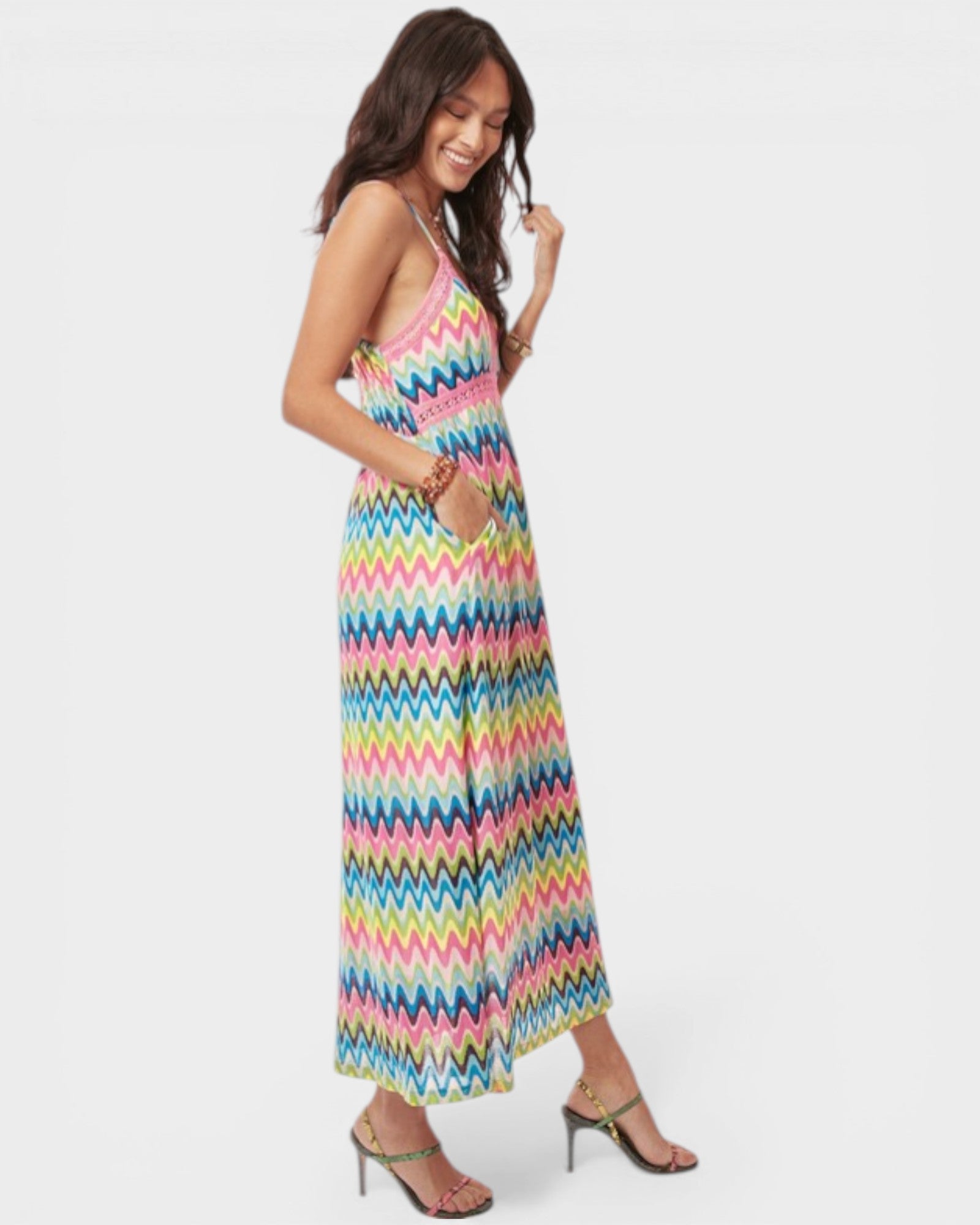 Woman wearing a colorful zigzag patterned dress on a white background