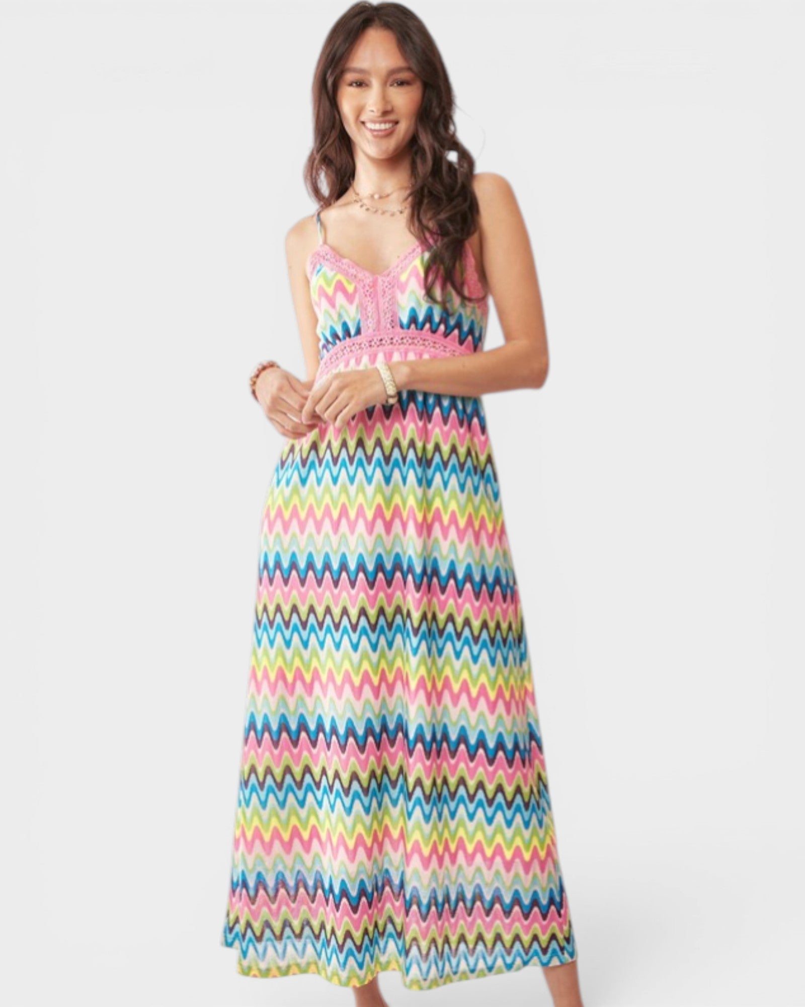 Woman wearing a colorful zigzag patterned dress on a white background