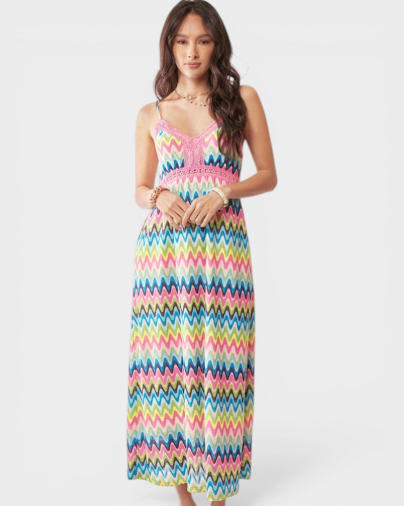 Woman wearing a colorful zigzag patterned dress on a white background