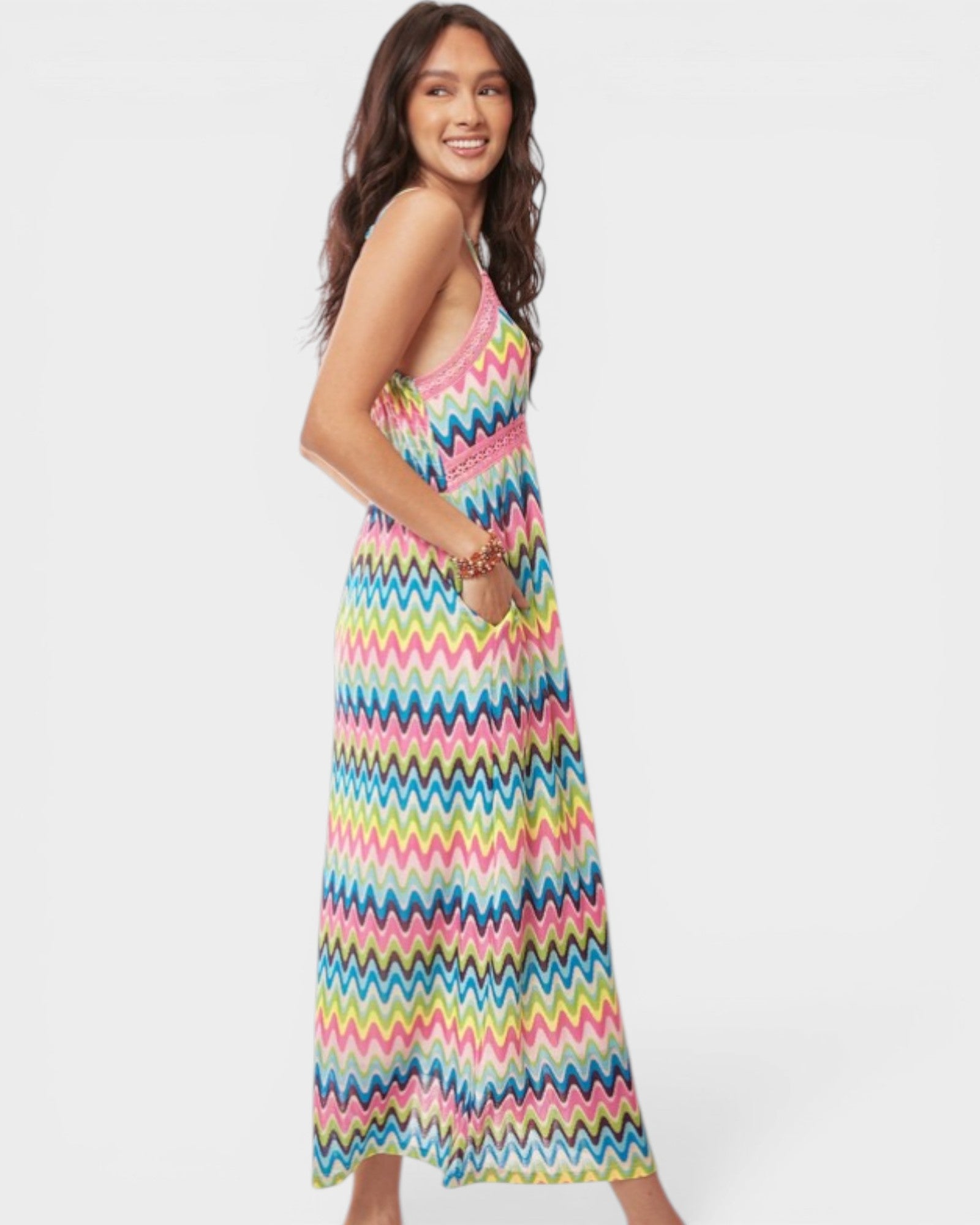 Woman wearing a colorful zigzag patterned dress on a white background