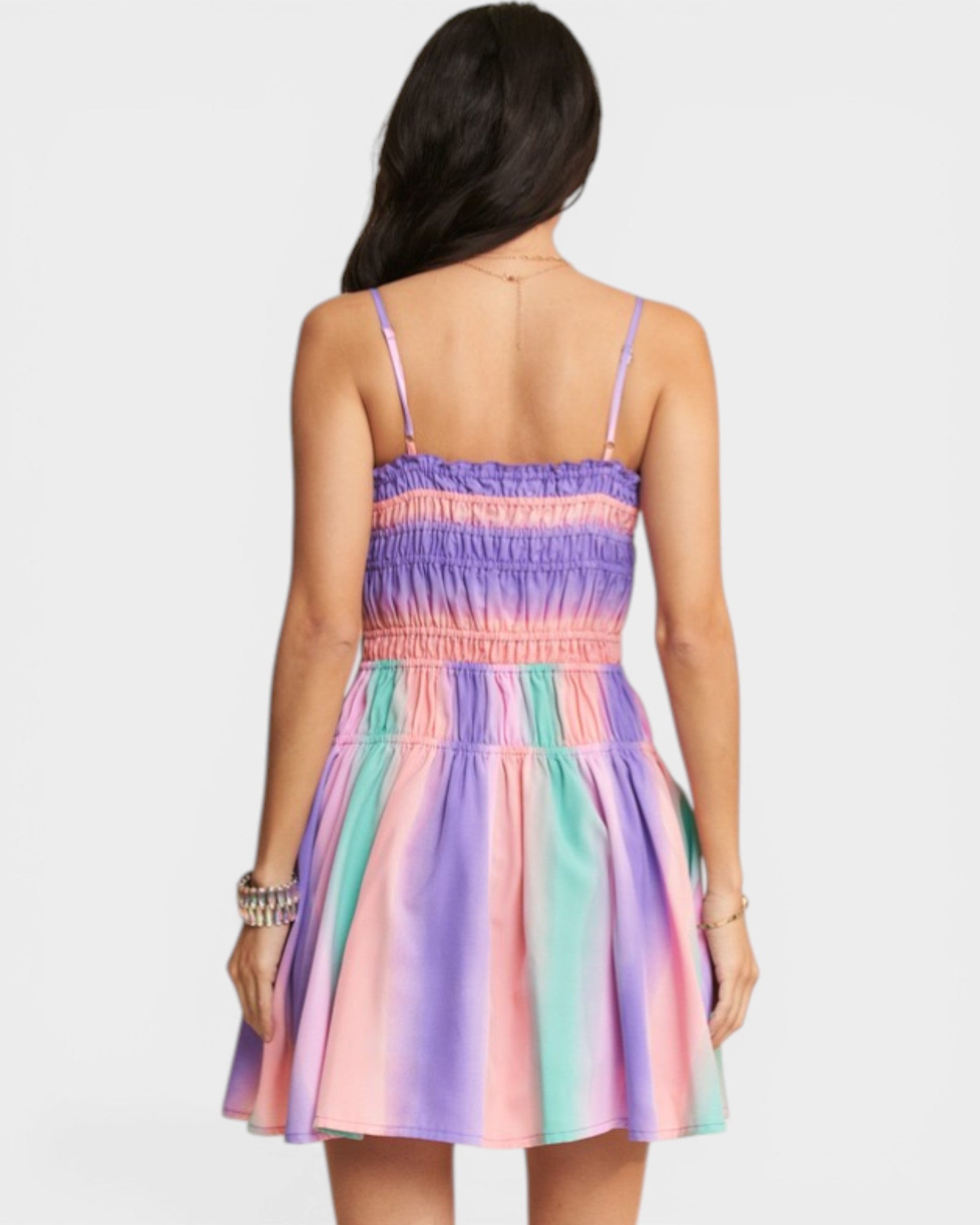 Multicolored dress worn by a person on a white background