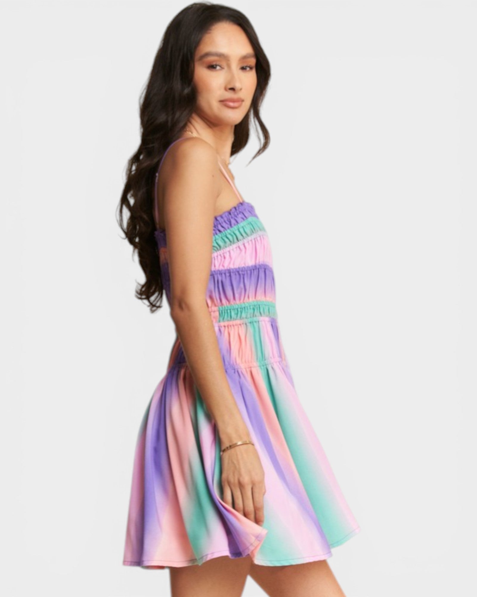Woman wearing a colorful striped dress on a white background