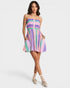 Woman wearing a colorful striped dress on a white background