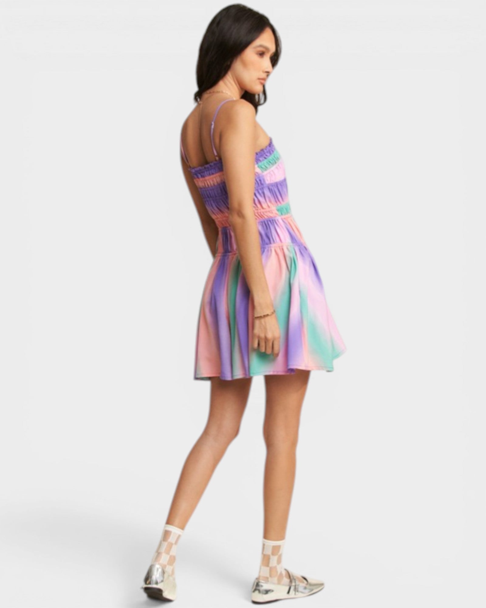 Woman wearing a colorful dress on a white background