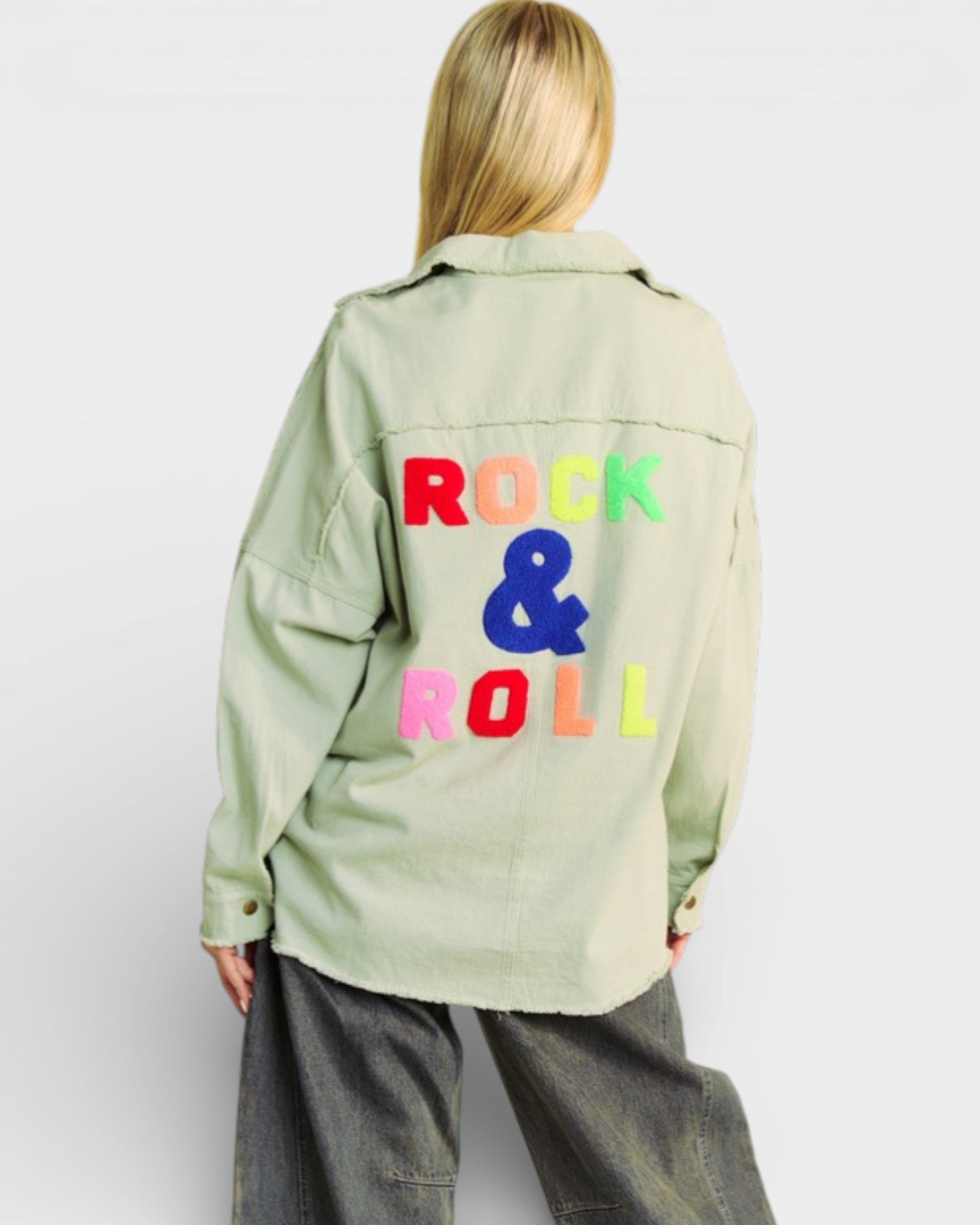 Person wearing a light green jacket with 'Rock & Roll' text on the back against a white background