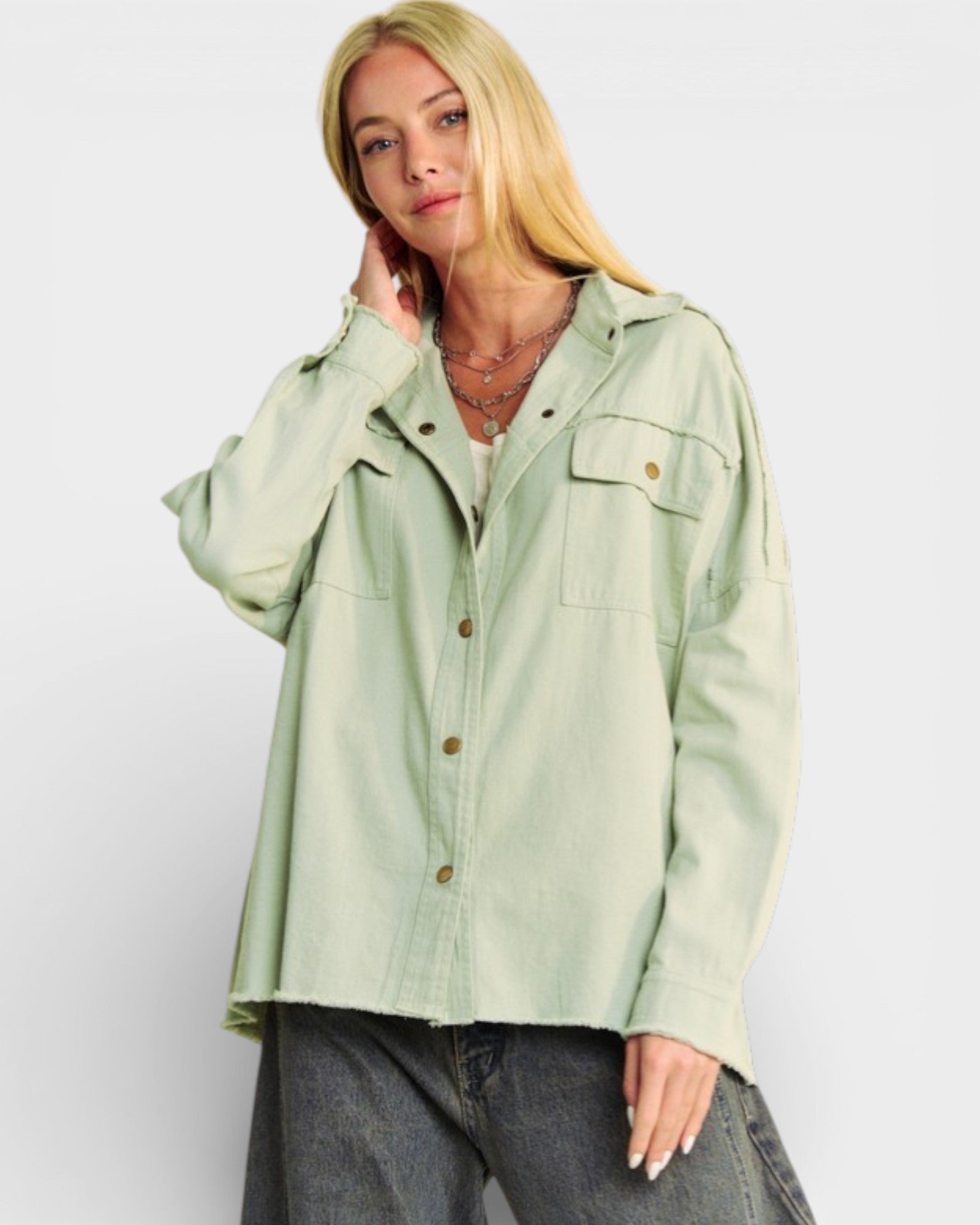Woman wearing a light green jacket on a white background