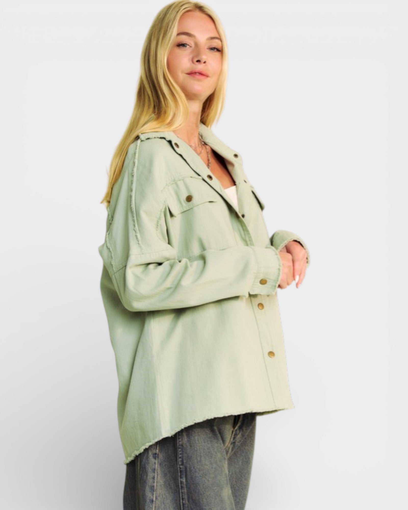 Woman wearing a light green jacket on a white background