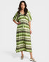 Woman wearing a green and white patterned dress on a white background