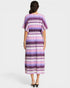 Woman wearing a patterned dress on a white background