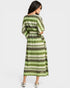 Woman wearing a green and gray patterned dress on a white background