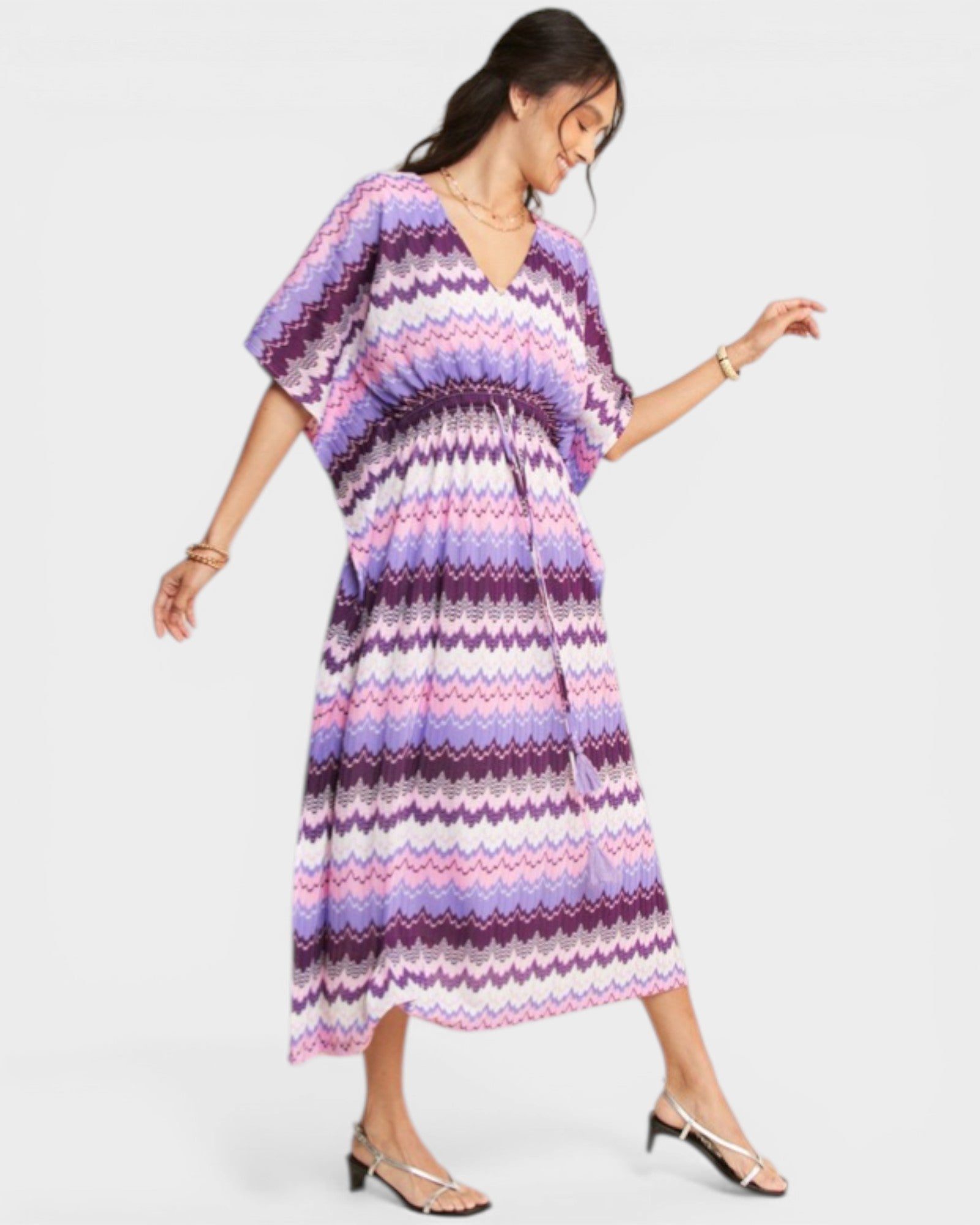 Woman wearing a colorful zigzag patterned dress on a white background