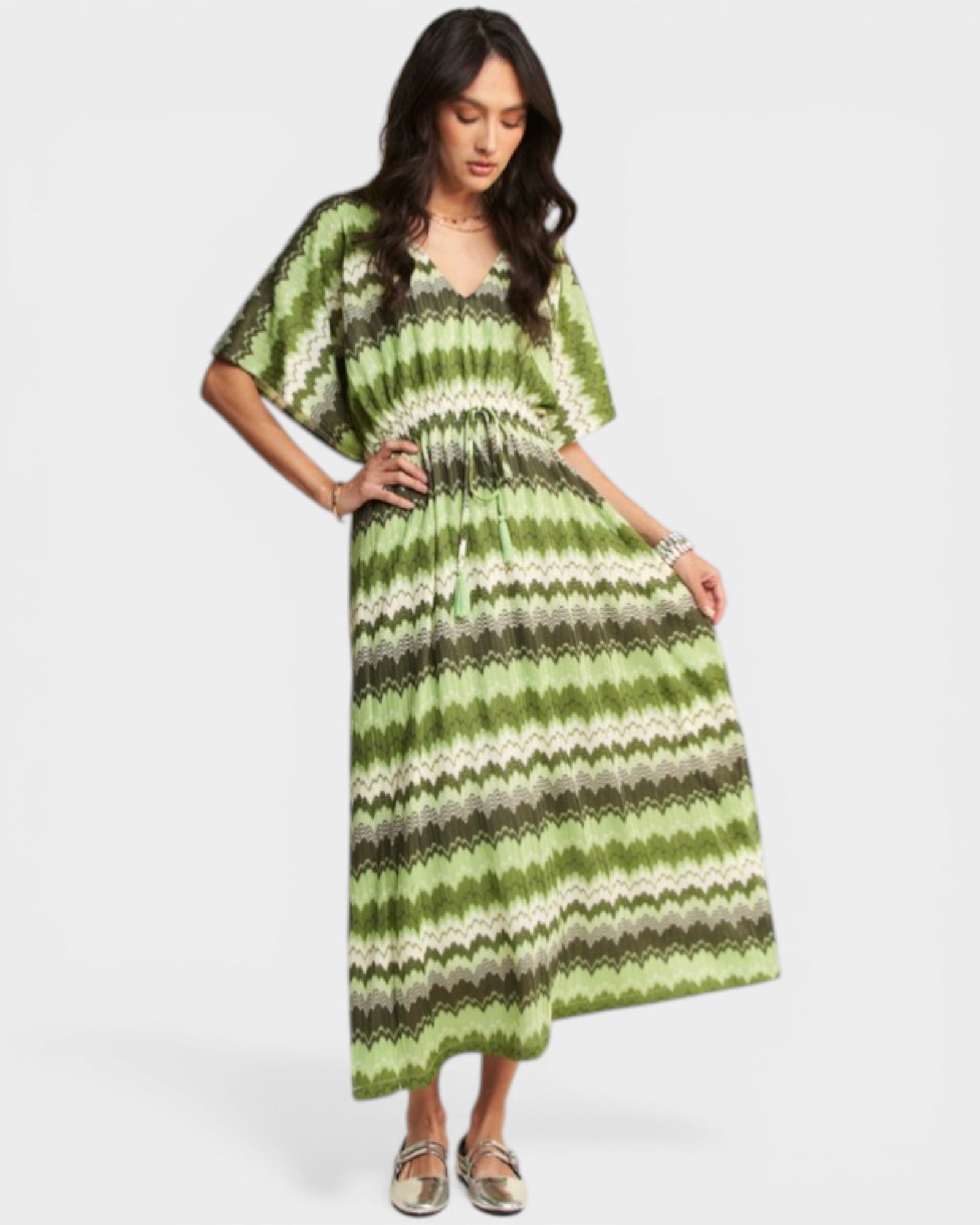 Woman wearing a green and gray striped dress on a white background