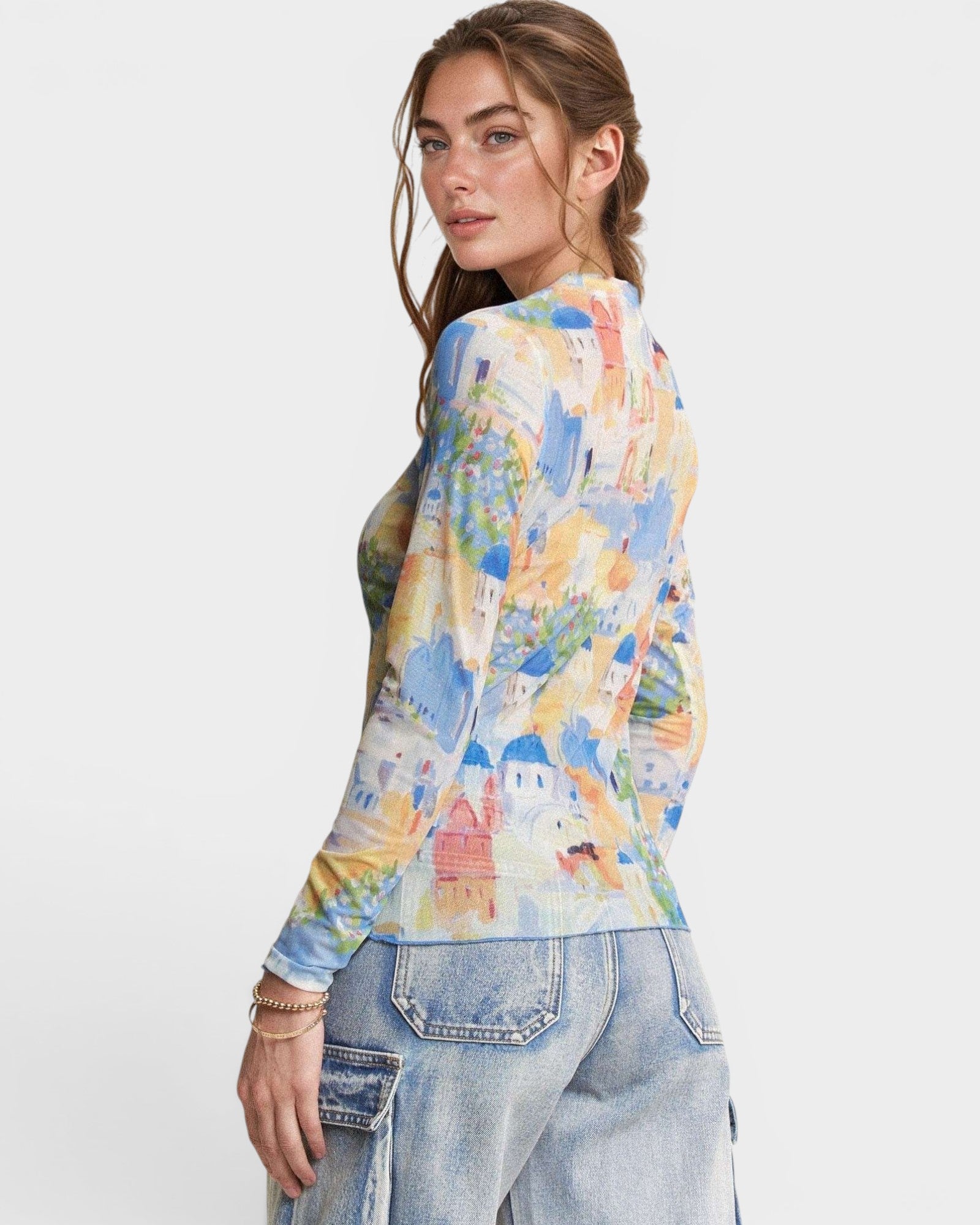Woman wearing a colorful patterned shirt with a white background