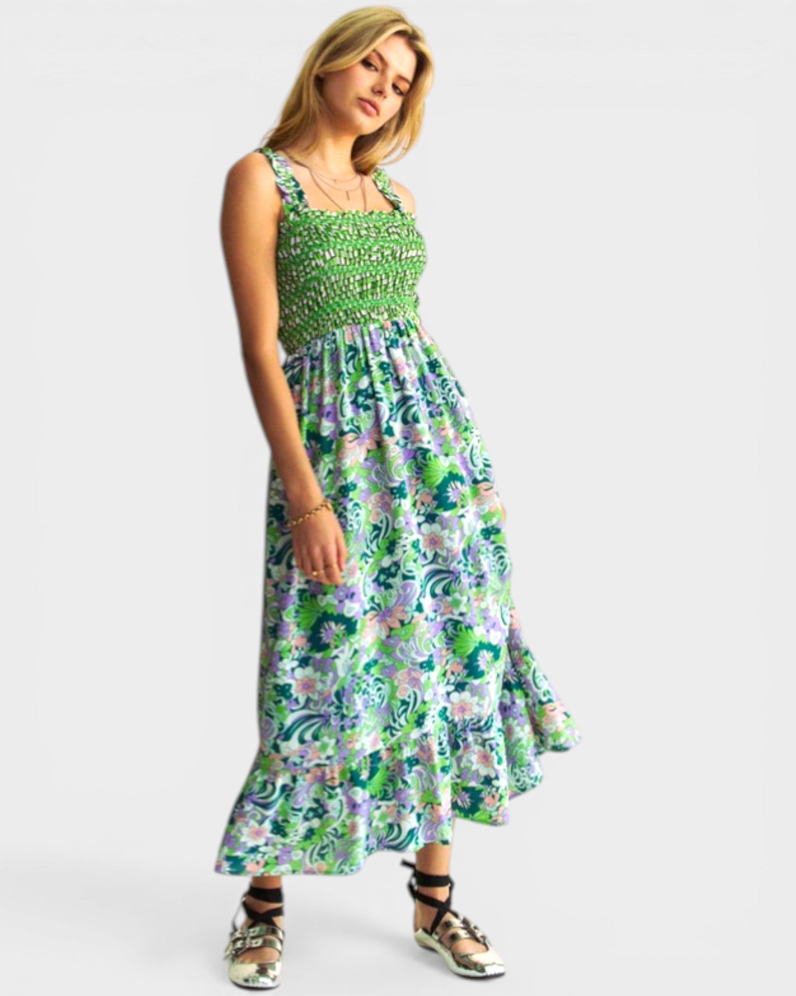 Woman wearing a green floral dress on a white background