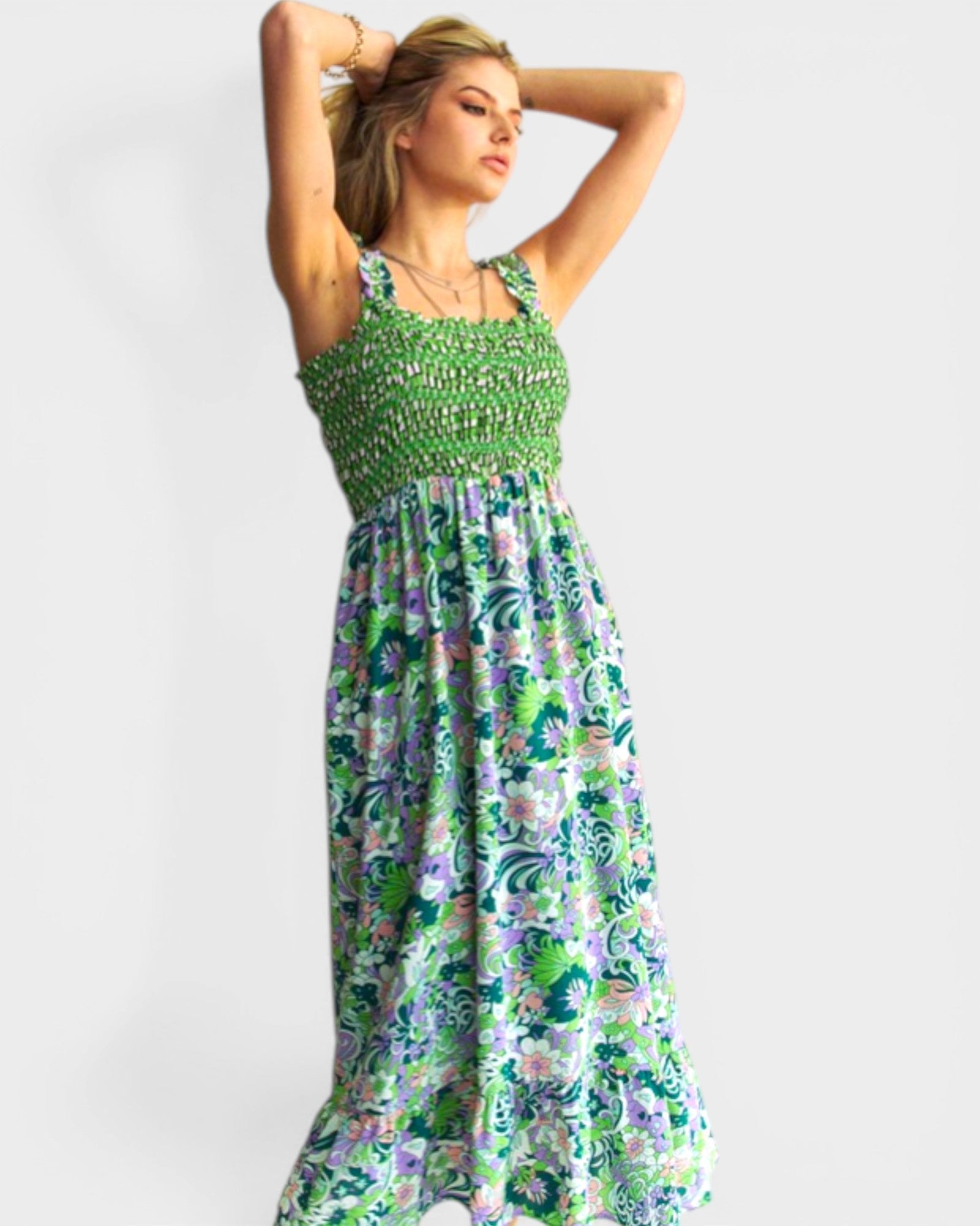 Woman wearing a green floral dress on a white background