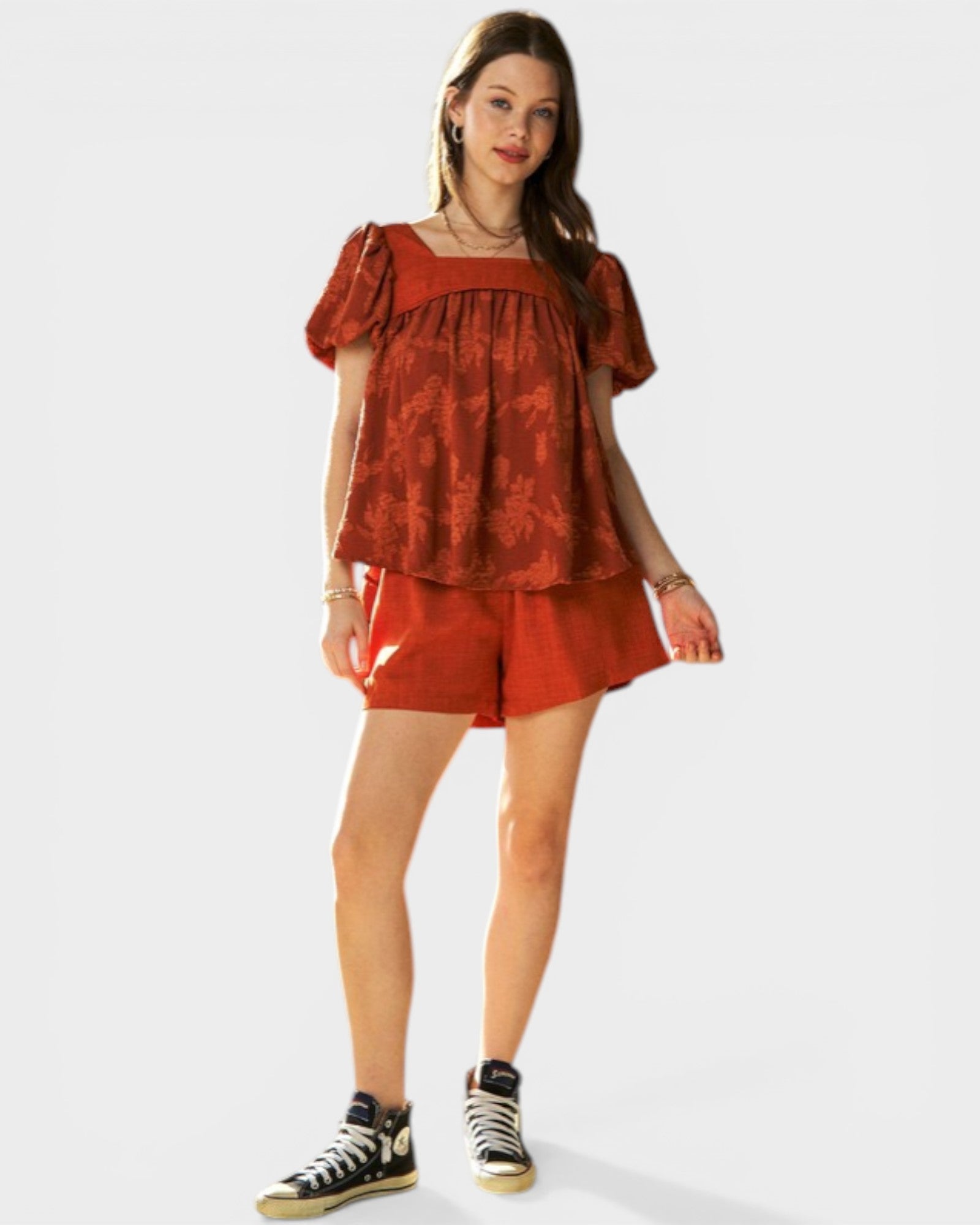 Woman wearing a red outfit with a white background