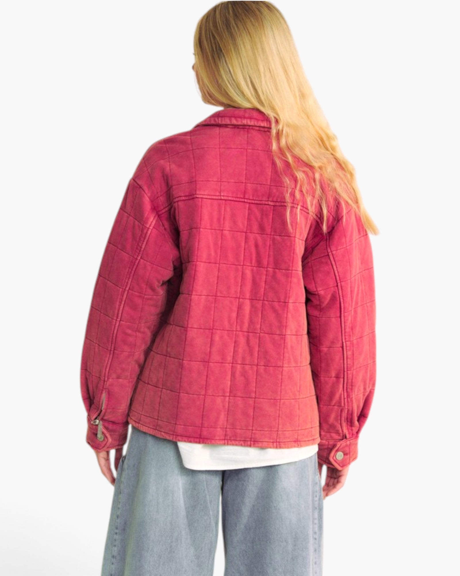 A woman shown from the back wearing a quilted pink jacket, light blue jeans, and a white t-shirt, against a plain white background.