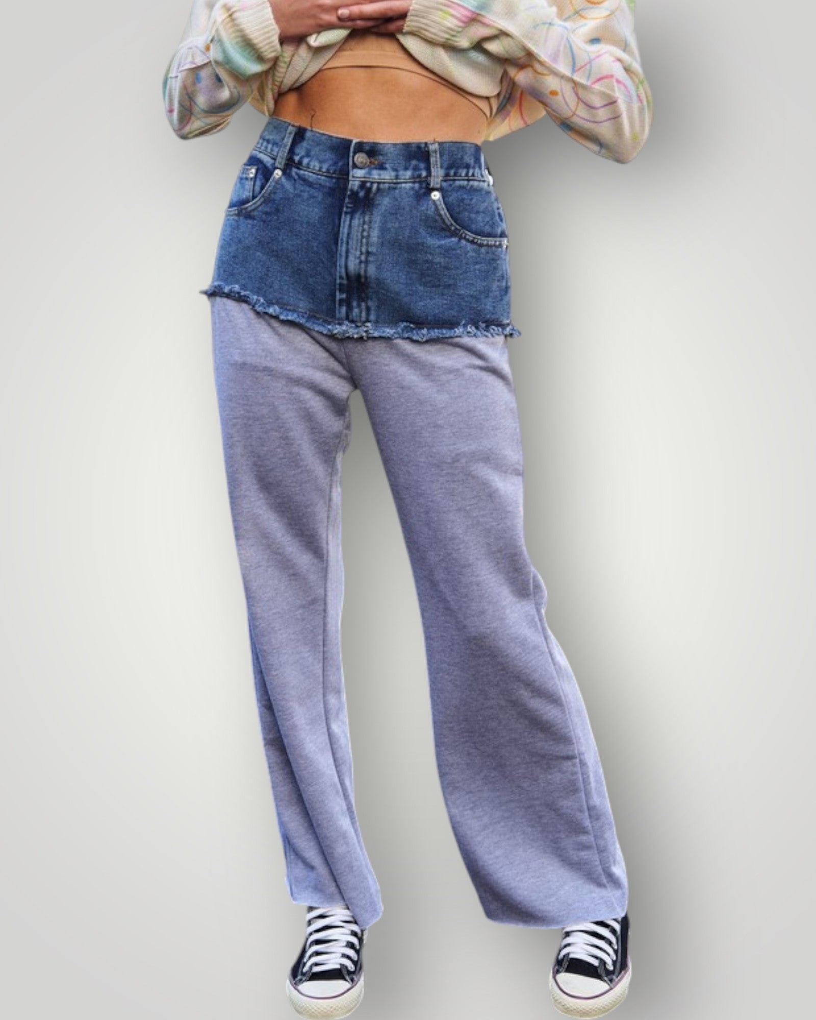 Person wearing a plaid shirt, denim jacket, and blue jeans on a plain background